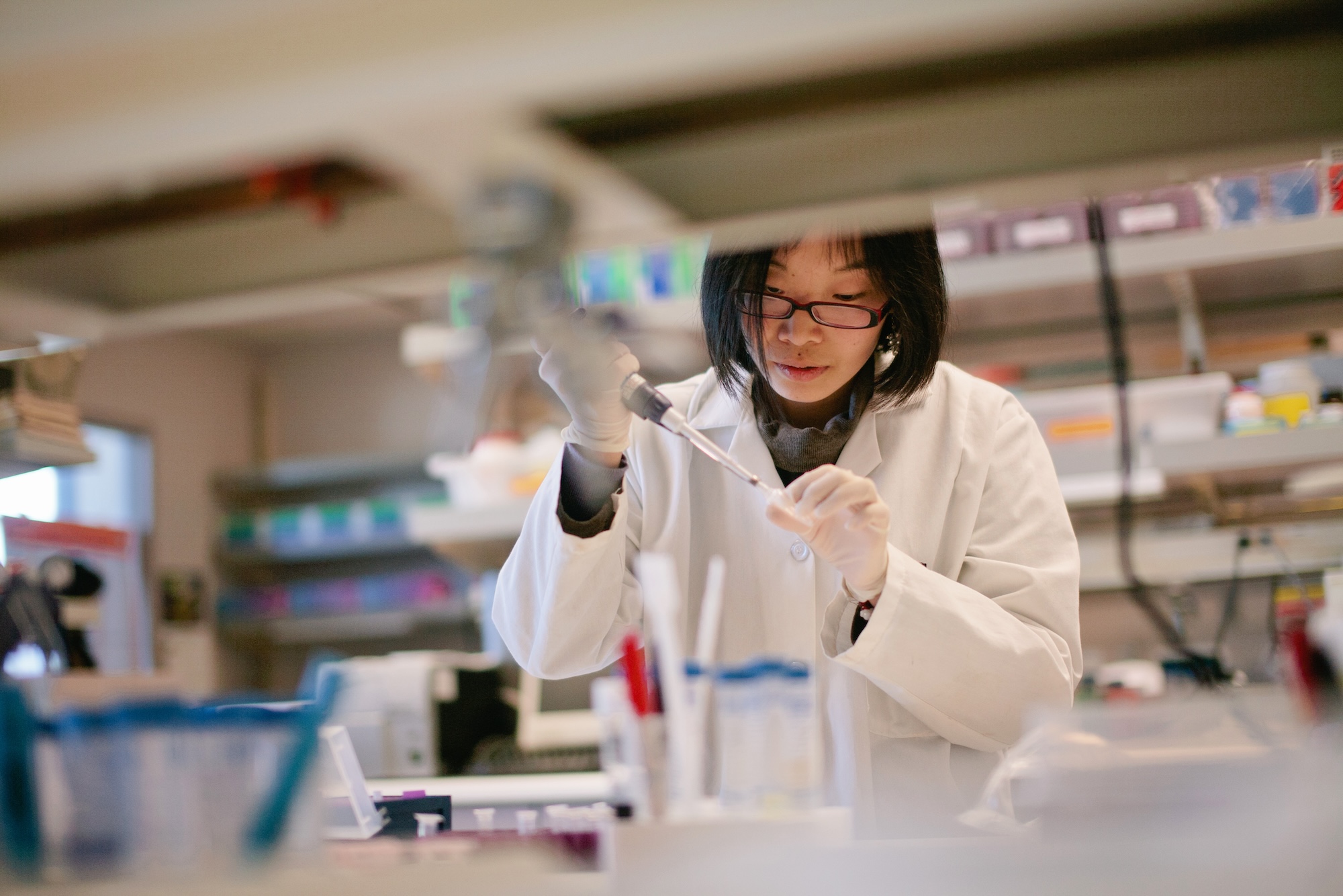 A medical researcher performs tests in a lab
